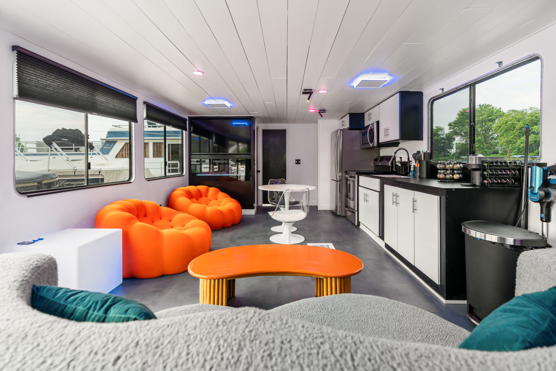 FIVE7 Yacht main salon with orange bubble sofa and full kitchen